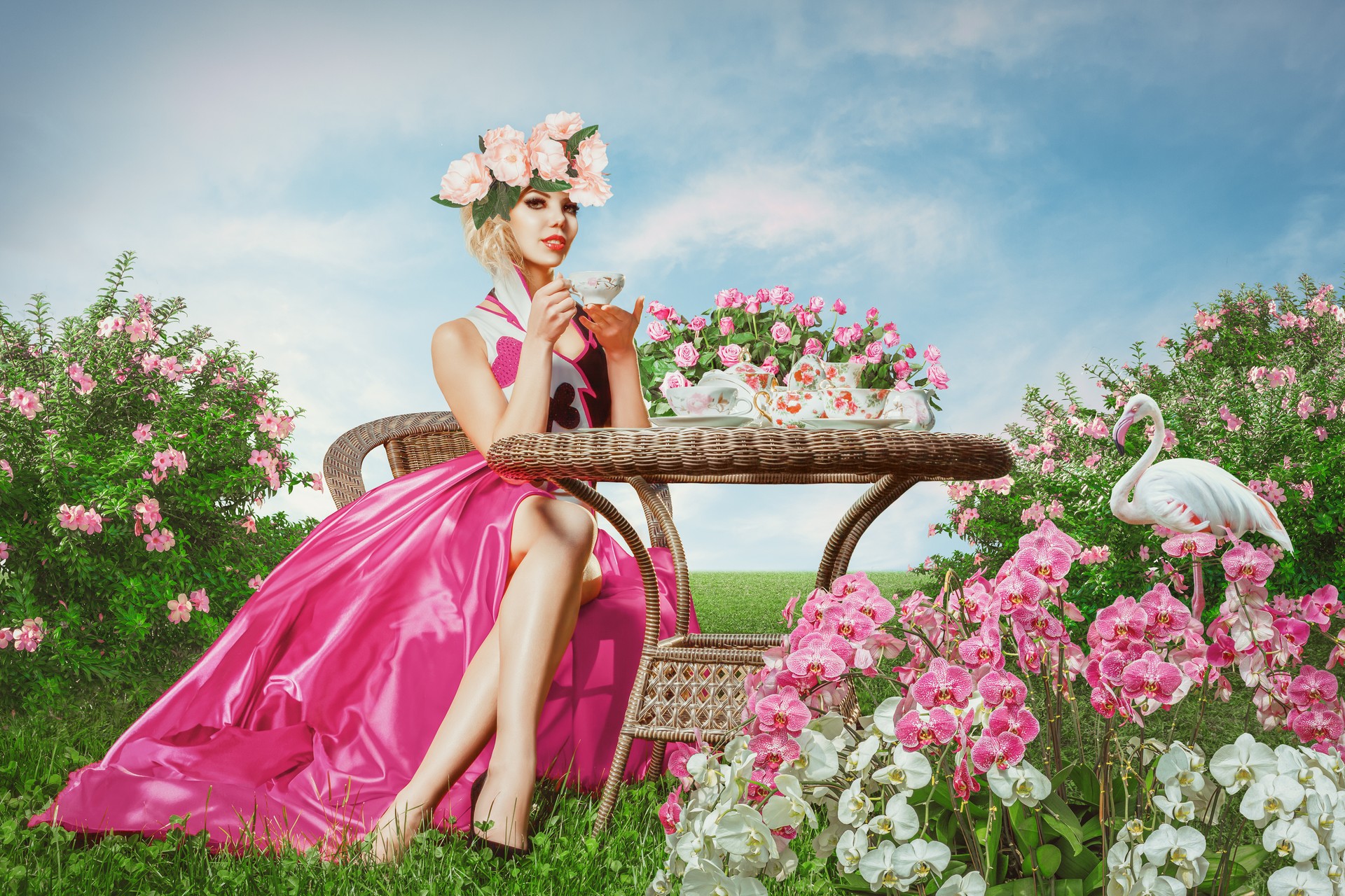 Young woman with flowers sipping tea at a garden tea party