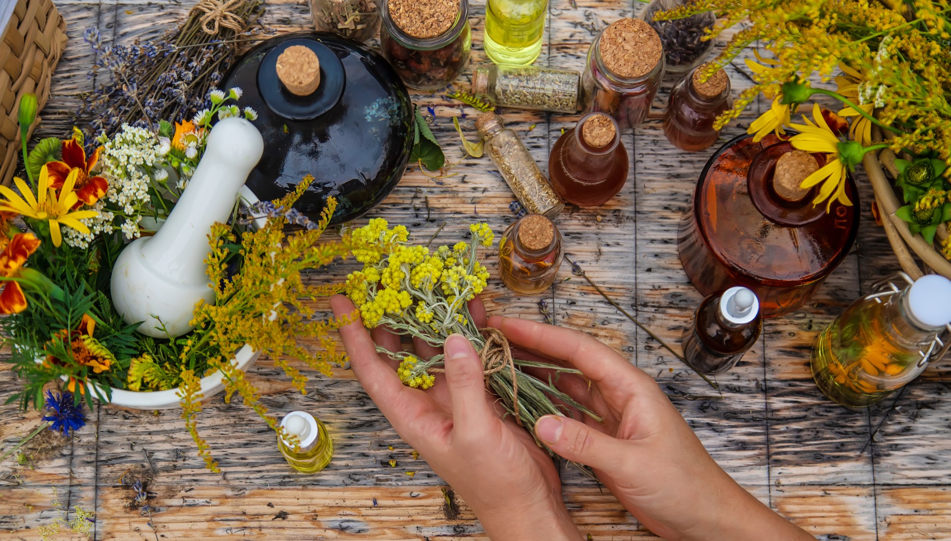 Woman with medicinal herbs and tinctures. Selective focus.